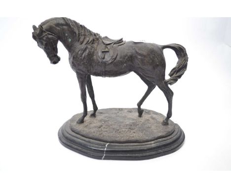 Spelter model of a racehorse on oval base mounted on a black marble type base, 30cm long