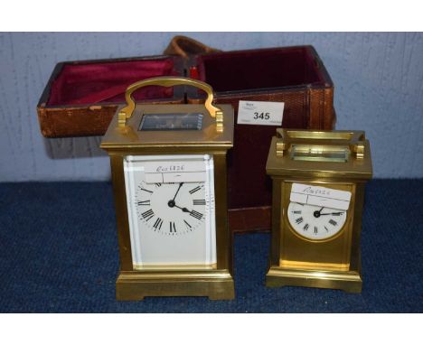 A carriage clock in case together with a smaller example