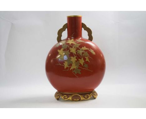 Large Royal Worcester moon flask, early 20th Century, the orange ground with gilt floral decoration on a gilt base, 38cm high