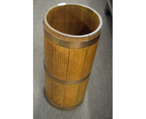 Late 19th or early 20th Century oak and copper bound stick stand of circular form, 62cm high