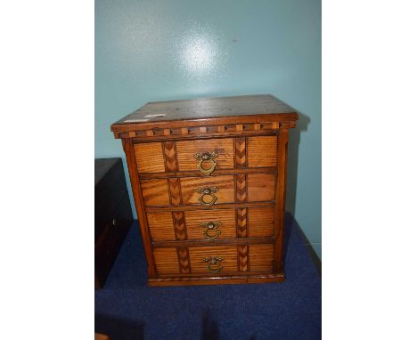 Small inlaid light oak chest with brass handles and four drawers, 37cm high