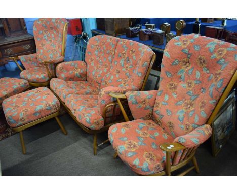 Ercol stick back three piece suite together with accompanying pair of stools, largest piece 140cm wide