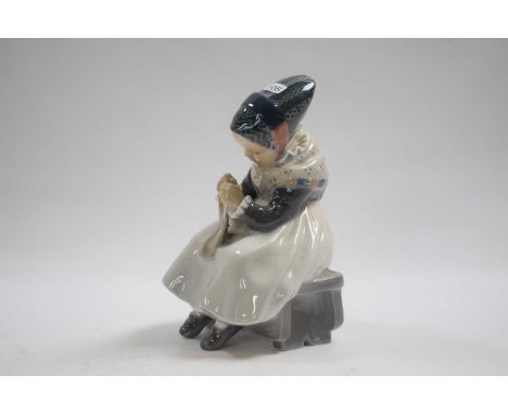 Royal Copenhagen model of a young girl seated on a bench sewing, 17cm high 