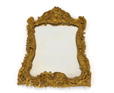 An Antique gilt wall mirror, profusely decorated with shells, fish and foliate scrolls, 95cm x 56cm