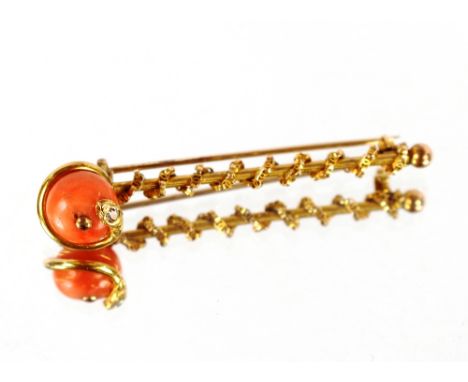 An unusual yellow metal bar brooch, set with a coral apple finial and coiled serpent with diamond head, 6.5cm long