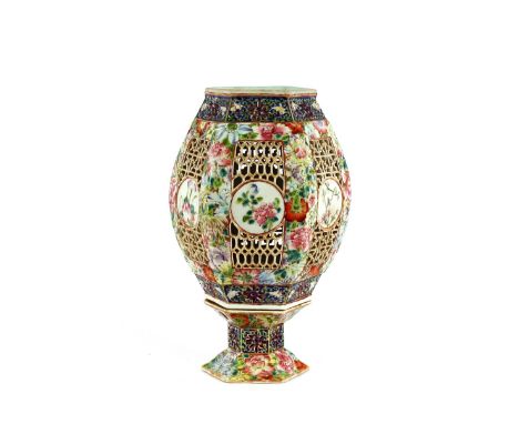 A 19th Century Chinese night light on stand, of hexagonal form with famille rose and pierced decoration, 28cm high