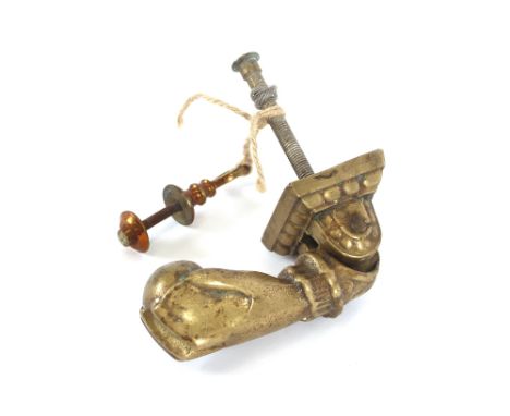 An early 20th Century brass hand and ball door knocker