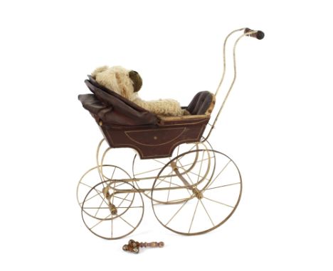 A Victorian doll's pram, with folding hood and spoked metal wheels; a vintage toy dog and a child's rattle