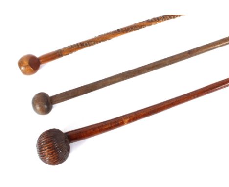 A knobkerrie, a carved Indian stick; and a hard wood staff, (3) 