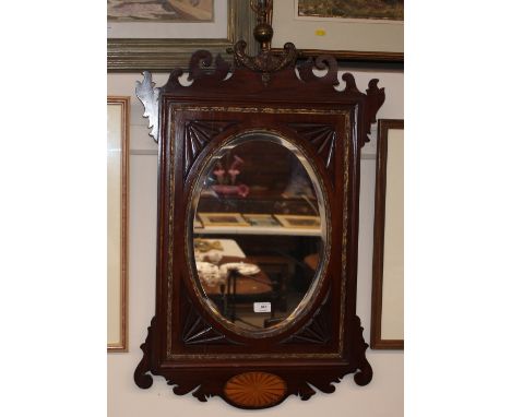 A late 19th Century mahogany and satinwood inlaid wall mirror, in the Chippendale manner, having fret carved pediments, surmo