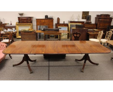 A large reproduction mahogany twin pillar extending dining table, with two extra leaves, 302cm x 122cm