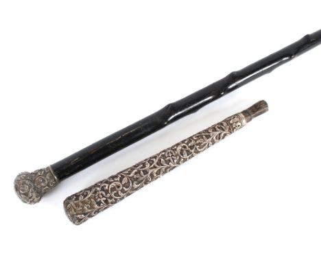 A Victorian hawthorn walking stick, with foliate embossed silver handle; and an Oriental white metal parasol handle, profusel