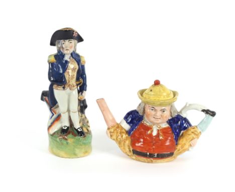 A Staffordshire pottery jug, depicting Nelson, 30cm high; and a Staffordshire novelty teapot, (2)