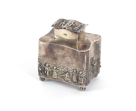 An Edwardian silver tea caddy, profusely decorated with rural scenes and raised on ball feet, Chester 1907, 11cm high