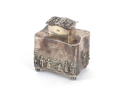 An Edwardian silver tea caddy, profusely decorated with rural scenes and raised on ball feet, Chester 1907, 11cm high