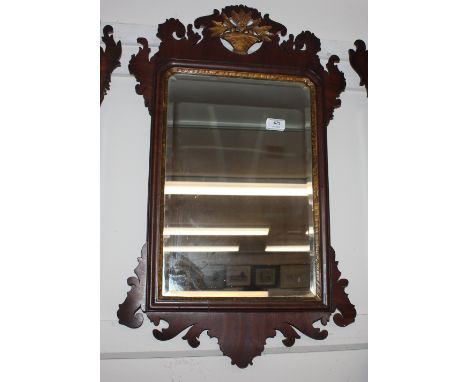 A 19th Century mahogany Chippendale style wall mirror, the fret carved frame with gilt basket of flowers motif, 76cm x 46cm