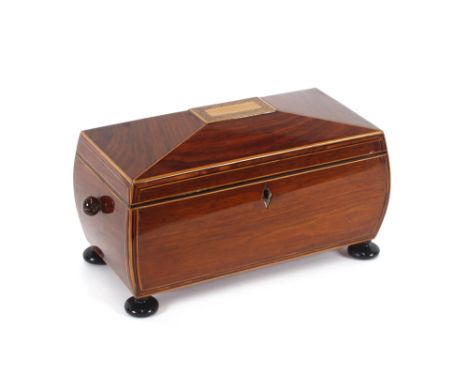 A 19th Century rosewood and satinwood inlaid sarcophagus shaped tea caddy, the interior fitted two compartments and a central