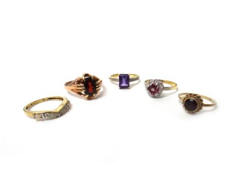 An 18ct gold, ruby and diamond set cluster ring, a gold ring claw set with an oval cut garnet, detailed 9CT, a 9ct gold ring 