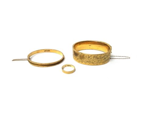 A 9ct gold oval hinged bangle, the front with floral and foliate engraved decoration, on a snap clasp, a gold oval hinged ban