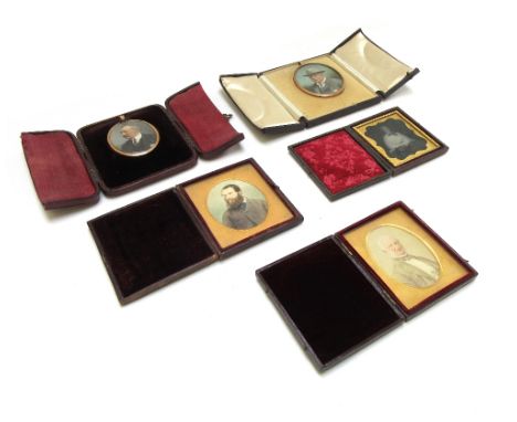 An oval portrait miniature of a gentleman, in a gilt frame and four further items, mostly photographic portraits with cases, 