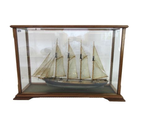 A scale model sailing ship, 'Tide', painted and fully rigged in a mahogany glazed case, 77cm wide.