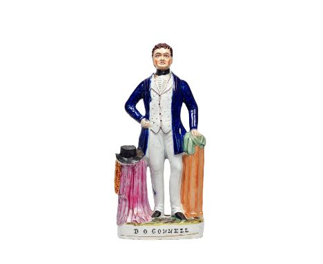 A Staffordshire portrait figure of Daniel O'Connell, 19th century, polychrome painted in a blue coat beside a draped pedestal
