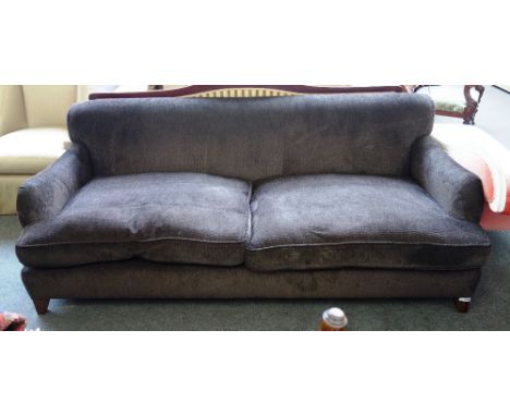 A 20th century brown upholstered three seat sofa, on tapering block supports, 220cm wide x 82cm high.