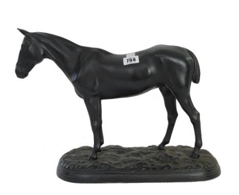 A black painted metal model of a horse, early 20th century, raised on a naturalistic shaped base, 30cm high.