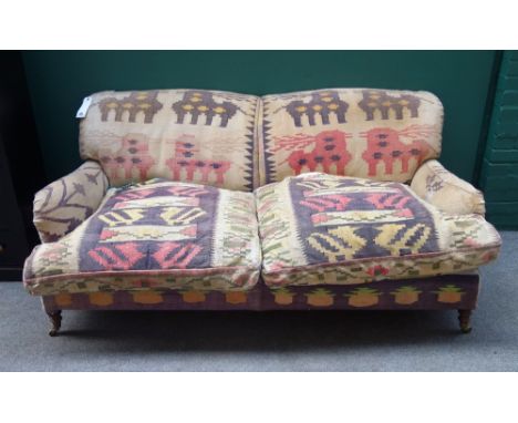 A Howard style sofa with Kilim upholstery, on turned supports, 182cm wide x 83cm high. 