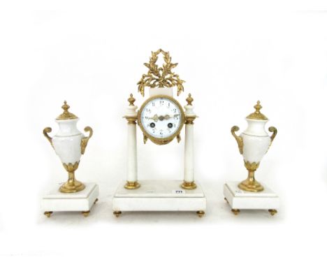 A French Empire style mantel clock garniture, early 20th century, the drum case with foliate painted white enamel dial flanke