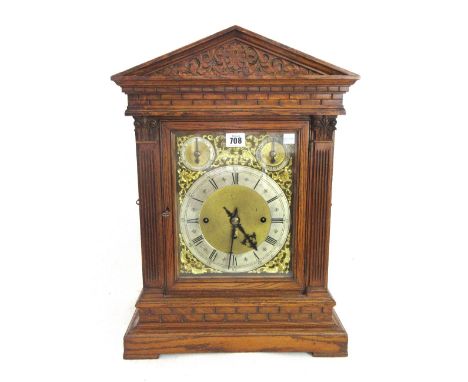 A German oak cased mantel clock, late 19th century, of architectural form, with silvered chapter ring and subsidiary slow/fas