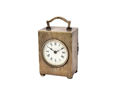 A silver rectangular cased carriage clock timepiece, the circular enamelled dial with black Roman numerals, the case with eng