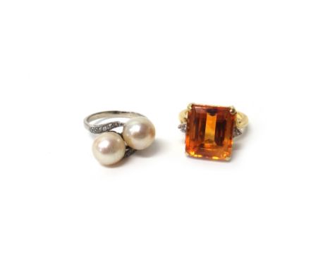 A gold ring, claw set with a cut cornered rectangular step cut citrine at the centre, between two circular cut diamonds, in a