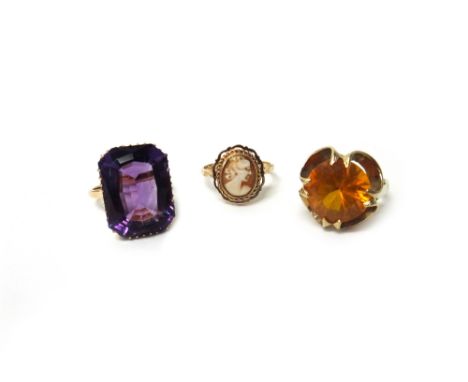 A gold ring, claw set with a cut-cornered rectangular cut amethyst, detailed '18ct', a 9ct gold ring, claw set with a circula