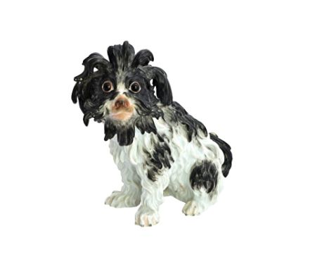 A Meissen porcelain model of a Bolognese hound, late 19th century, after a model by J. J Kaendler, black patch markings, seat