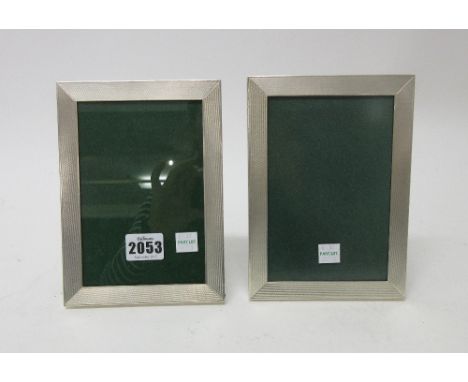 Two similar silver mounted rectangular photograph frames, having engine turned decoration to the borders, differing modern da