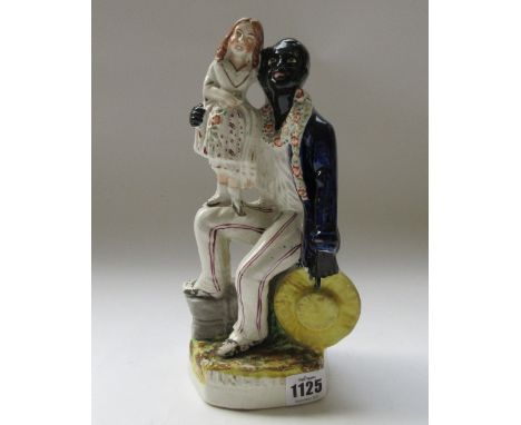 A Staffordshire portrait group, 'Uncle Tom', 19th century, polychrome painted on a gilt titled base, 27cm high, another of a 