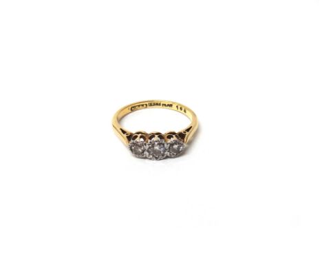 A gold and platinum, diamond set three stone ring, mounted with a row of circular cut diamonds, detailed '18ct PLAT', ring si