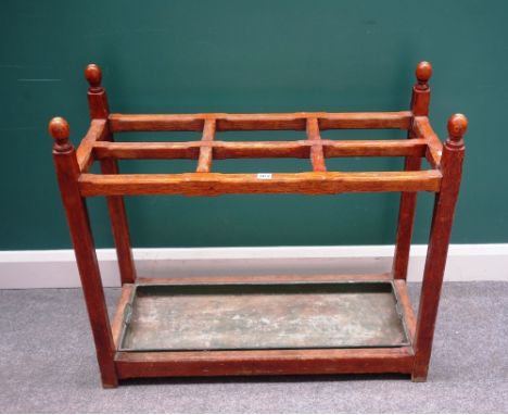 A Victorian oak six division stick stand, with chamfered square supports and sphere finials, 91cm wide x 81cm high.