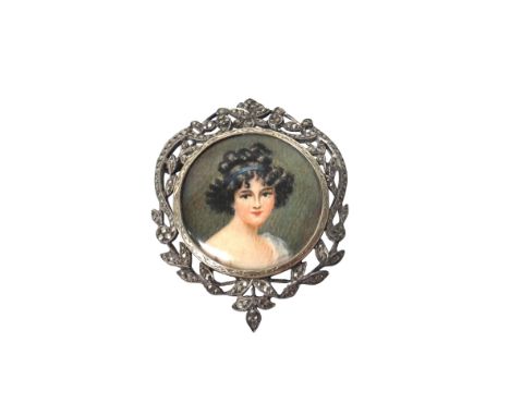 A silver and marcasite set brooch, glazed to the centre with a portrait miniature of a lady, within a scroll and foliate wrea