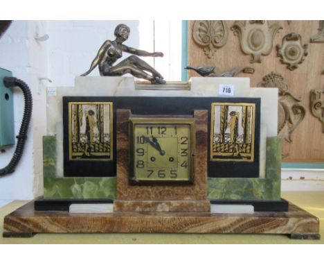 An Art Deco mantel clock, alabaster, onyx and striated marble, with a silver plated female nude and two ducks over a square f