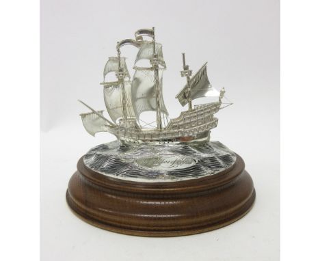A silver limited edition model of The Golden Hind, in sail at sea, mounted to an oak base, modern. 