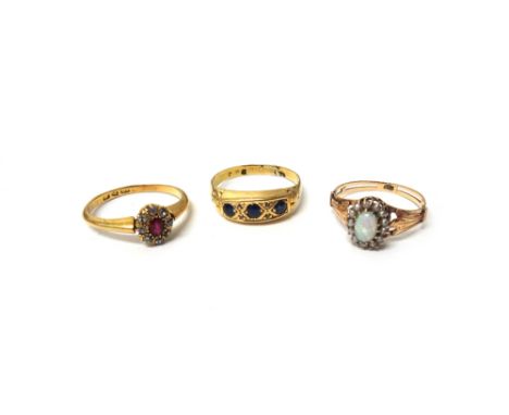An 18ct gold, ruby and diamond set nine stone oval cluster ring, Chester 1912, a gold, opal and seed pearl set oval cluster r