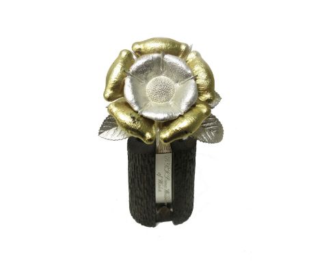 A silver and gilt model of a single rose, raised on a rustic stand, detailed H.R.H. Prince William of Wales by Christopher La