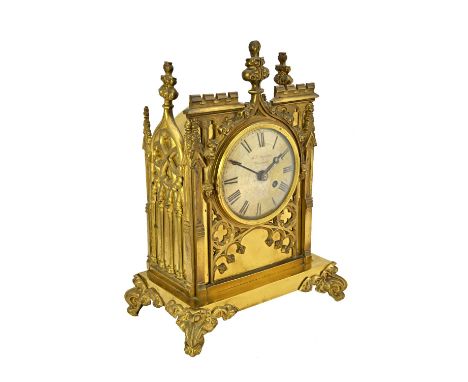 A gilt brass cased mantel clock, 19th century, of Gothic cathedral form, the silvered dial detailed 'J.H. SAUNDERS WARMINSTER