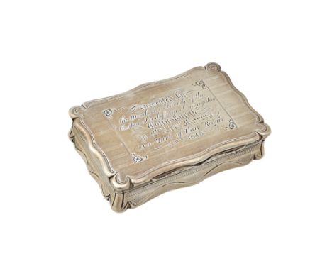 A Victorian silver hinge lidded snuff box, of shaped rectangular form, the cover presentation inscribed, otherwise engine tur