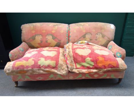 A Howard style sofa with Kilim upholstery, on turned supports, 182cm wide x 83cm high. 