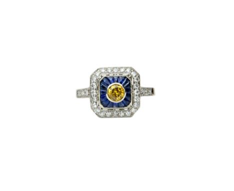 A platinum, diamond, yellow diamond and sapphire set ring, in a cut cornered square panel shaped design, collet set with the 