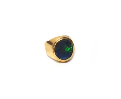 A gold and opal single stone ring, mounted with an oval opal, detailed 750, ring size J and a half, gross weight 6.3 gms.