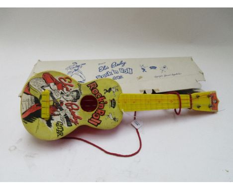 A vintage Selcol Elvis Presley toy guitar, boxed, 53cm long.  